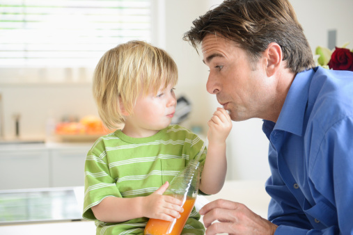 Zoontje laat papa drinken uit een fles met rietje